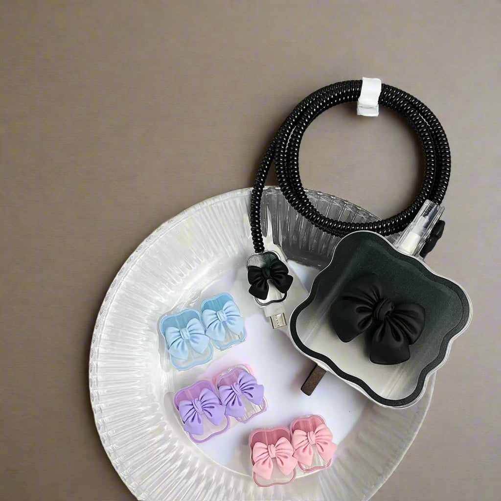 Set of colorful bow-shaped clips on a clear dish with a gray background