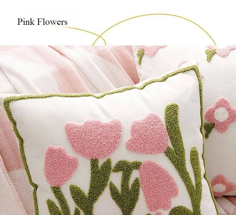 Decorative pillow with pink floral design on a soft pink background