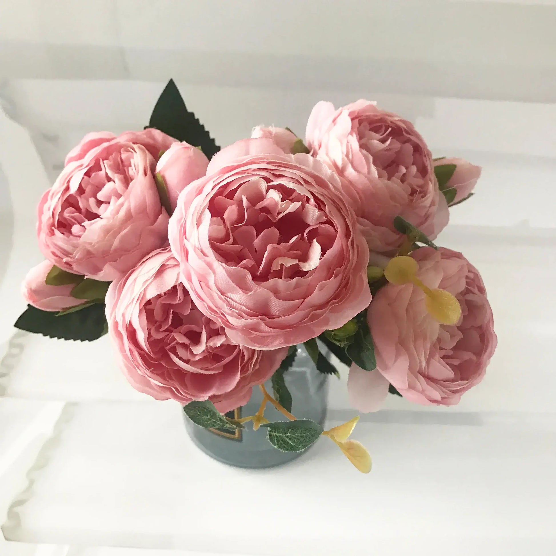 Add timeless beauty to your space with this stunning rose pink silk peony bouquet. Made with high-quality silk, it features 5 full peony blooms.