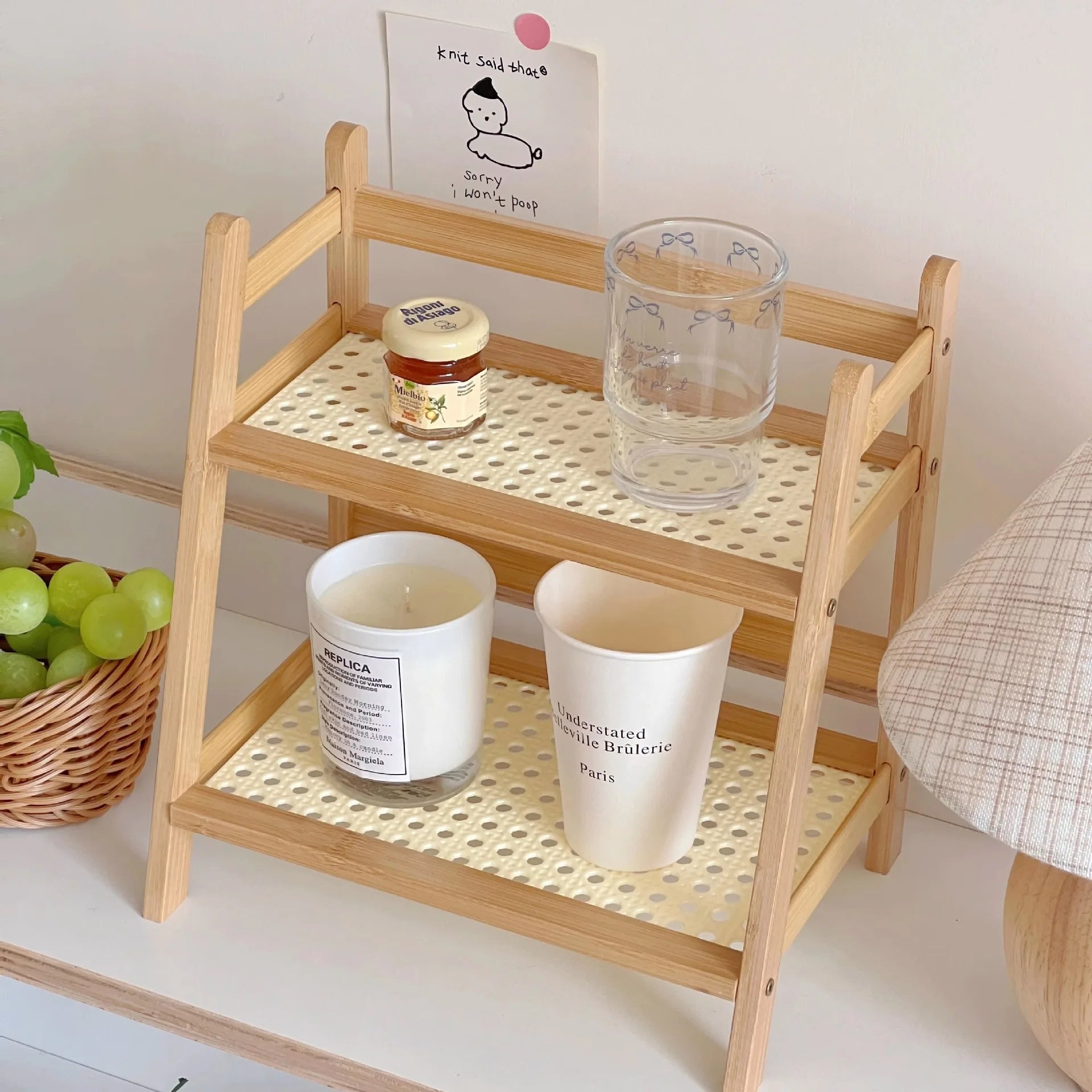 Wooden shelf with decorative items on a white surface