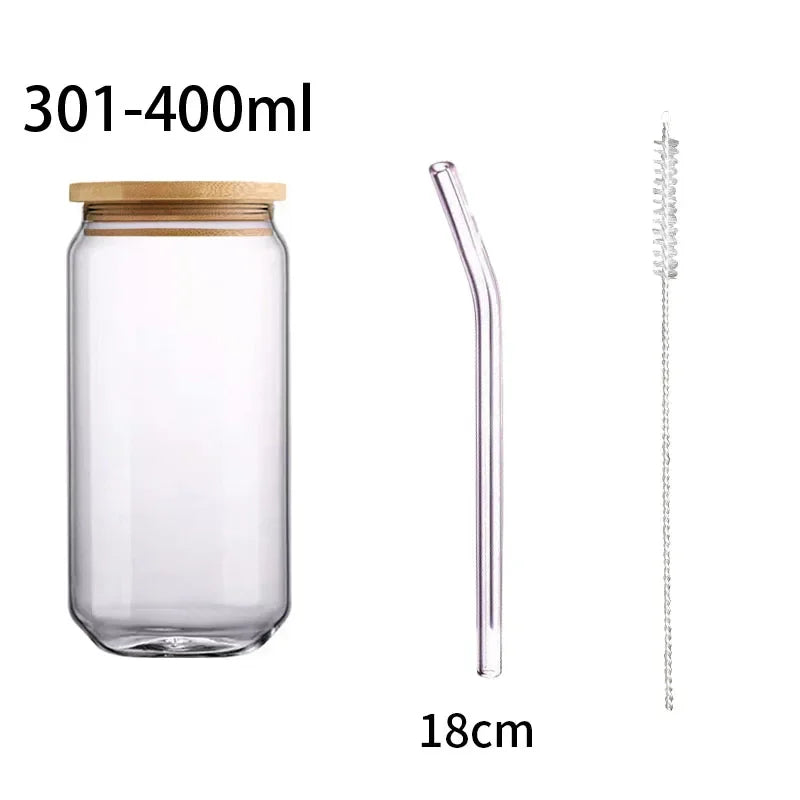Clear glass jar with wooden lid, glass straw, and cleaning brush on a white background