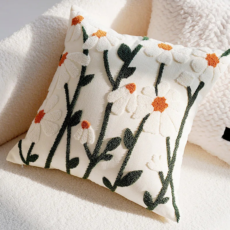 Decorative pillow with floral embroidery on a soft surface