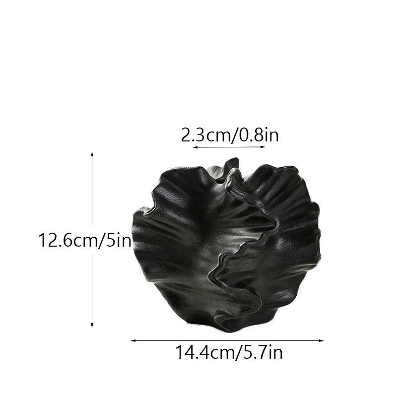 Black decorative item with measurements on a white background