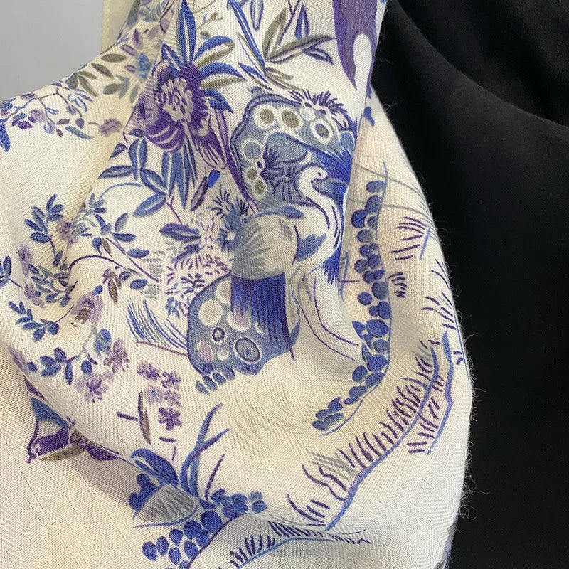 Close-up of a fabric with blue peacock and floral pattern on a beige background