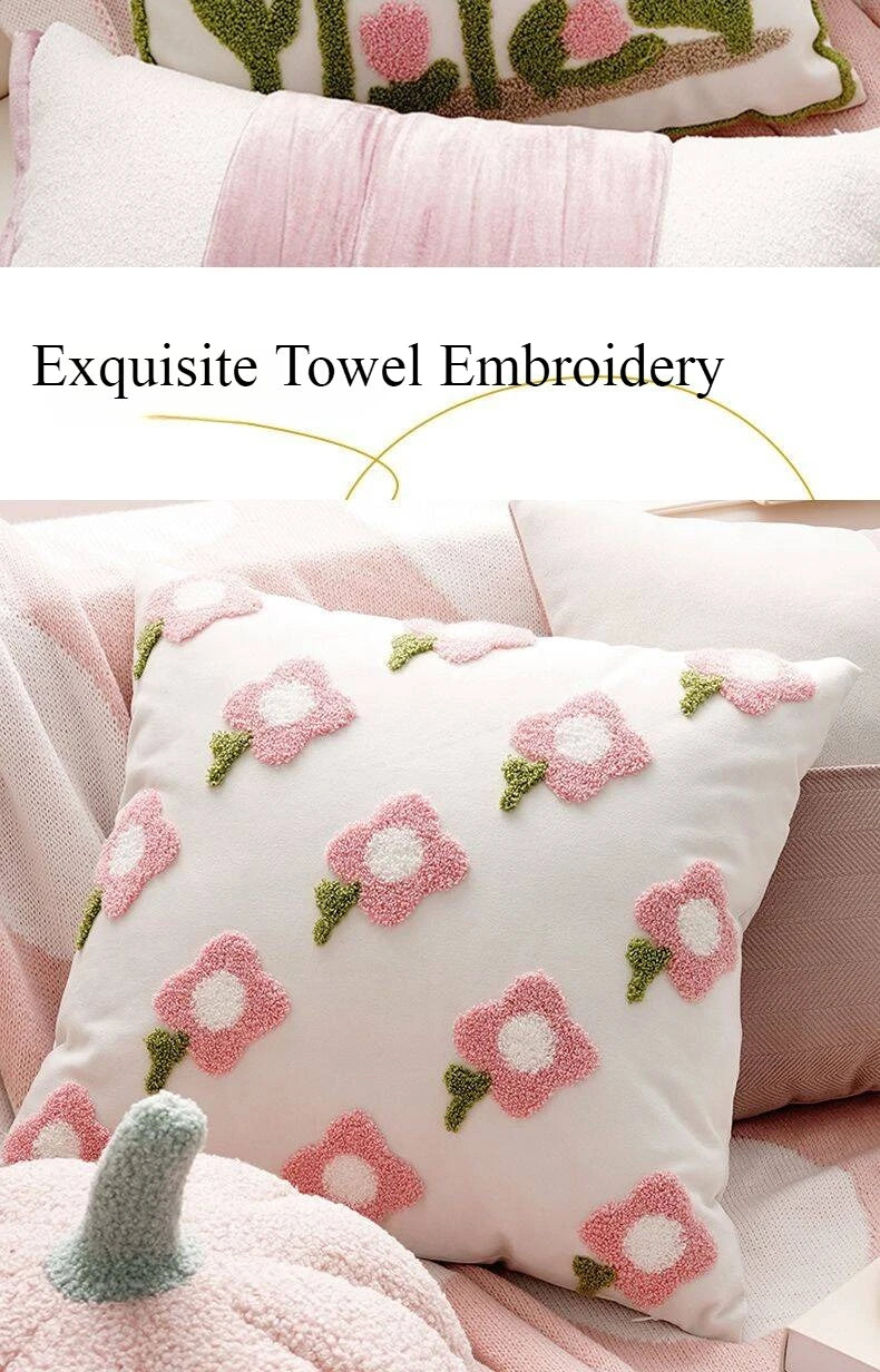 Decorative pillow with floral embroidery on a pink couch