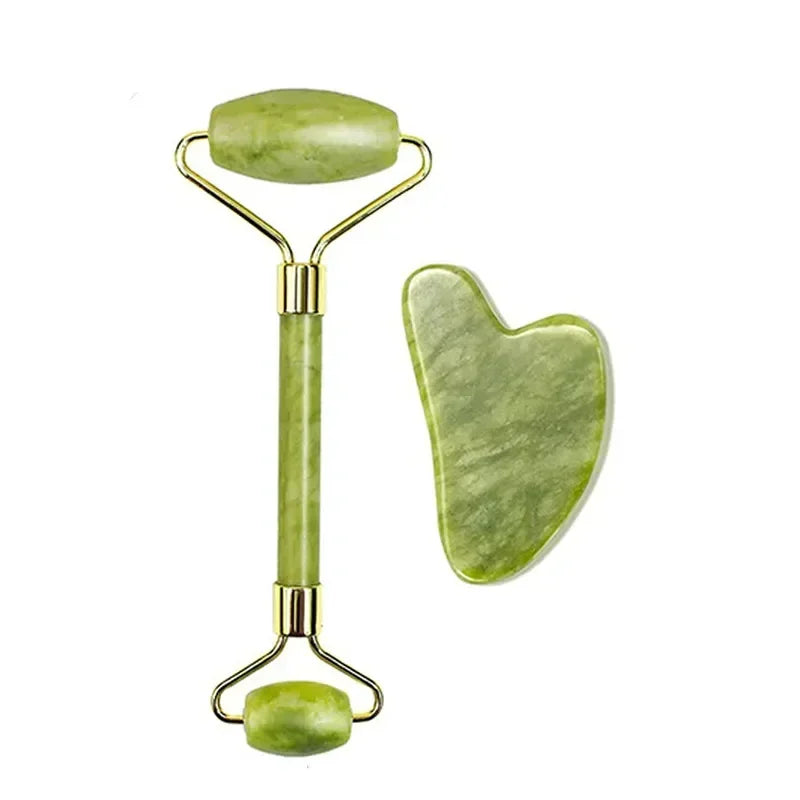 Green jade roller and gua sha tool on a white background