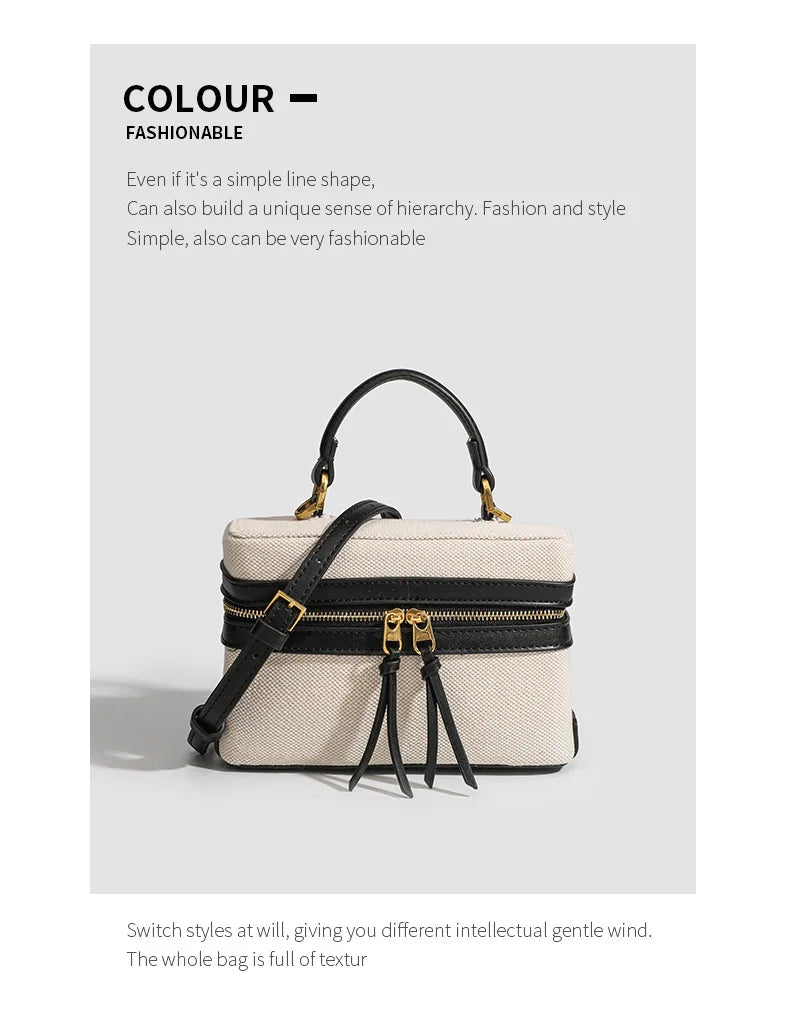 White handbag with black accents on a light gray background